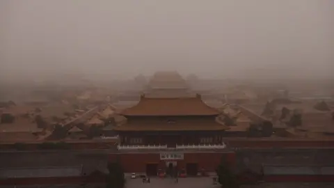 Reuters Forbidden City in Beijing is shrouded in yellow dust.