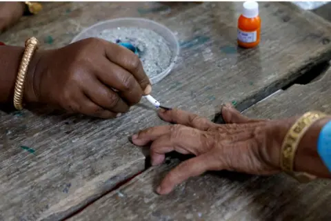 Reuters A woman gets her finger inked before casting her vote at a polling station during the first phase of the general election, in Alipurduar district of the eastern state of West Bengal, India, April 19, 2024. REUTERS/Sahiba Chawdhary