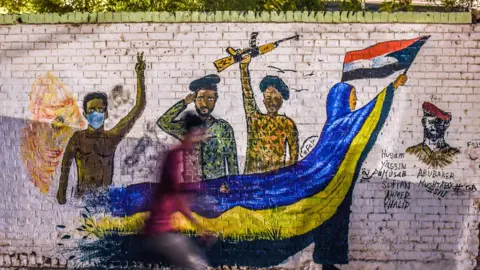 AFP A mural showing soldiers standing with the protesters in Khartoum, Sudan