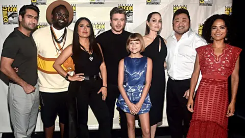 Getty Images The Eternals stars Kumail Nanjiani, Brian Tyree Henry, Salma Hayek, Richard Madden, Lia McHugh, Angelina Jolie, Don Lee and Lauren Ridloff