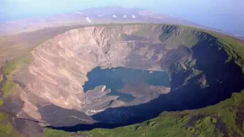 AFP Aerial picture taken on March 2005, of the Cumbre volcano's crater, in the Galapagos Islands,