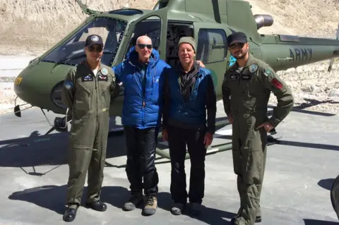 Sandy Allan Rick Allen, in blue jacket, and Sandy Allan with helicopter crew after Mr Allen's rescue