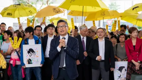 EPA Dr Chan Kin-man and his fellow accused before entering court