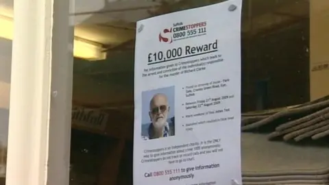 A reward poster in a shop window