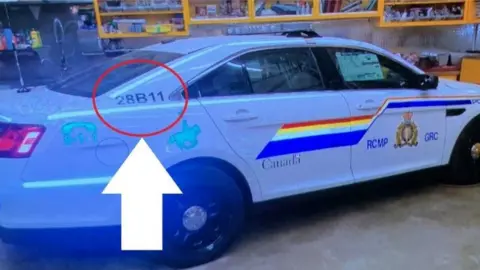 Reuters Police car believed to have been used by a gunman