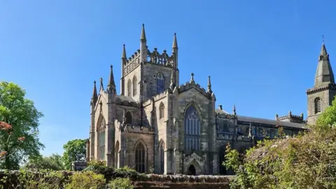 Dunfermline Abbey, a large religious building pictured in the sunshine