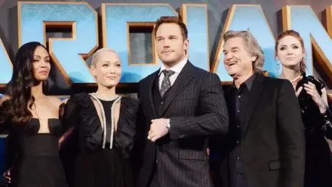 The cast of Guardians of the Galaxy lining up for a picture at a red carpet event.