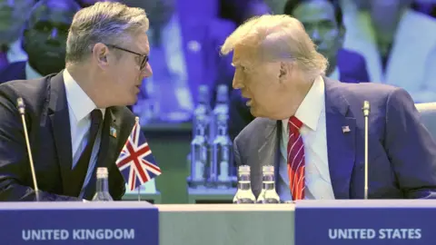 PA Media Left: Sir Keir Starmer wearing a dark suit and turning to his left to talk to Donald Trump. Right: Donald Trump wearing a blue suit with a white shirt and red tie with thin white pinstripes turning to his right to talk to Starmer.