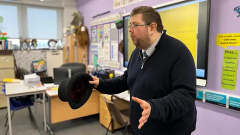 BBC/Branwen Jeffreys Dan Quirk often uses hats and costumes to help pupils remember their English lessons