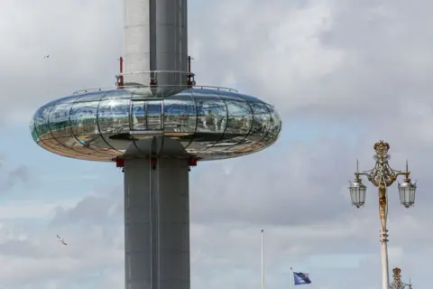 A circular glass viewing pod on a long grey circular structure.