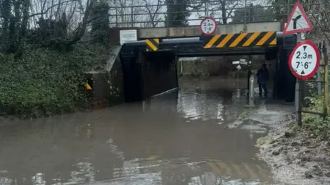 Kelly Pepper A flood road beneath a railway bridge