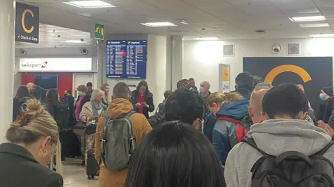 Rebecca Young/PA Media Huge queues at Birmingham Airport