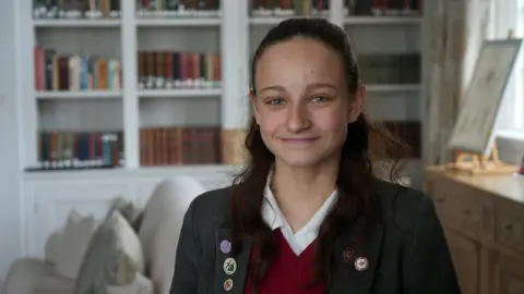Jamie Niblock/BBC School pupil Olivia, sitting in school library