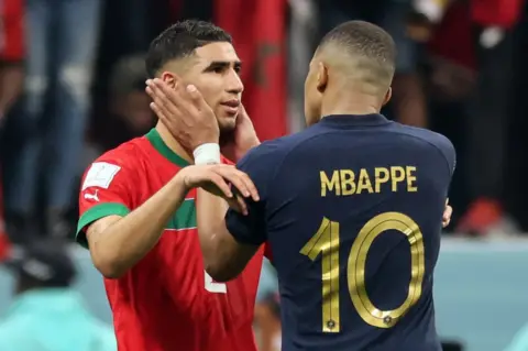 AFP France's forward Kylian Mbappe comforts Morocco's defender Achraf Hakimi at the end of the match.