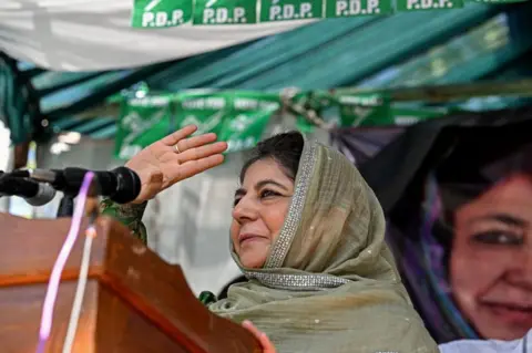 AFP Mehbooba Mufti, mantan Kepala Menteri dan Presiden Partai Demokratik Rakyat Jammu dan Kashmir (PDP), menyapa para pendukungnya selama rapat umum kampanye pemilu di Pulwama, selatan Srinagar, pada 10 September 2024, menjelang pemilihan majelis di Jammu dan Kashmir yang dikelola India.