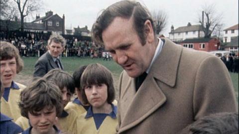 England manager Don Revie speaks to the Garthorpe Canaries at Ilkeston Town's Manor Ground.