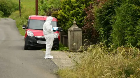 Pacemaker Person in forensic white suit on the road writing on a paper pad 