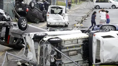 Reuters Vehicles blown over in Osaka