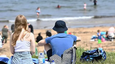 Pacemaker Crowds gather at Helen’s Bay Beach