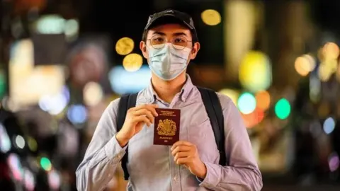 AFP Reese Tan, a 25-year old tutor, poses with his British National (Overseas), or BN(O),