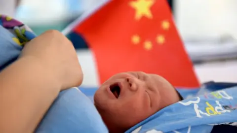 Getty Images Chinese baby in front of Chinese flag