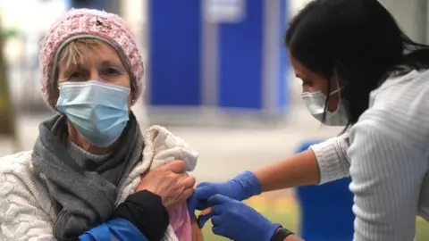 EPA Woman receiving Covid vaccine in London
