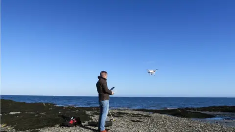 IOMGOV Man using drone