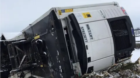 Snow in Dorset Lorry overturns and schools closed