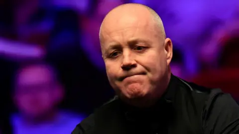John Higgins grimaces