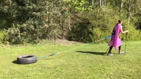 Preet Chandi Preet in Indian dress pulling a tyre