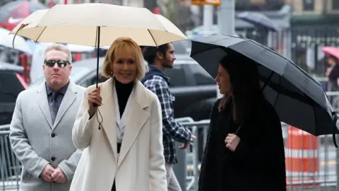 Reuters E. Jean Carroll walks outside the Manhattan Federal Court, for the second civil trial after she accused former U.S. President Donald Trump of raping her decades ago, in New York City, U.S., January 26, 2024