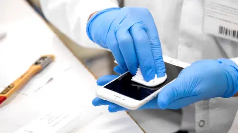 Back Market Phone screen being cleaned