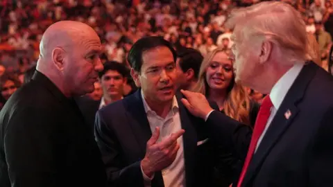Pool/Reuters U.S. President Donald Trump talks with U.S. Secretary of State Marco Rubio and UFC CEO Dana White while attending UFC 327 at Kaseya Center in Miami, Florida.