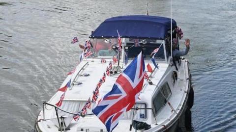 A boat with Union Jack flags 
