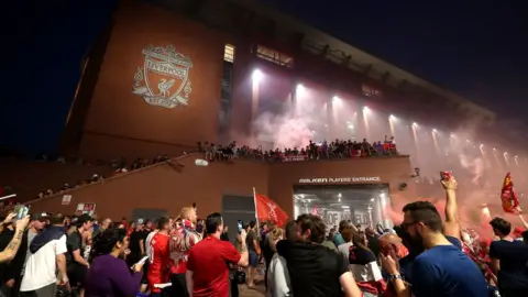 PA Media Liverpool fans celebrate outside Anfield