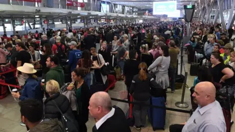 EPA Passengers endure delays at Sydney Airport on Monday