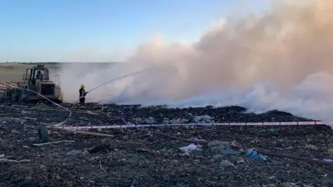 Cambridgeshire Fire and Rescue Service Smoke rising over Milton recycling centre
