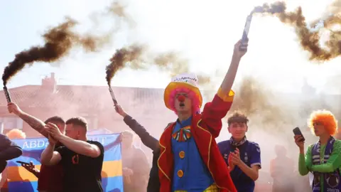 Getty Images protesters hold flares aloft