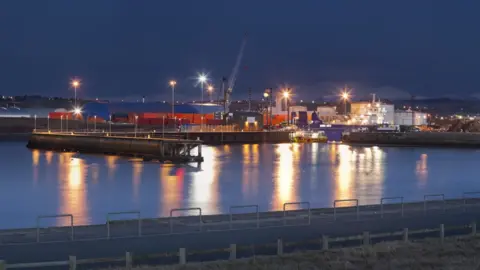 Getty Images Lights illuminate Workington harbour