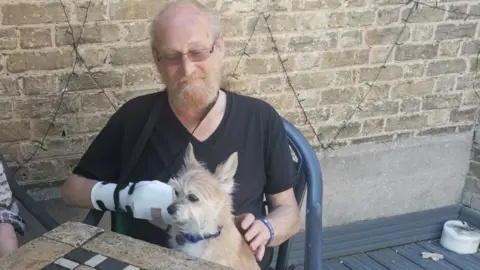 Louisa Pilbeam/BBC Nick Phillipowsky and injured terrier