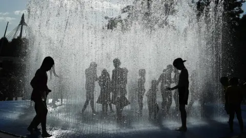 EPA Children play in the fountains by the River Thames in London on 6 August 2018