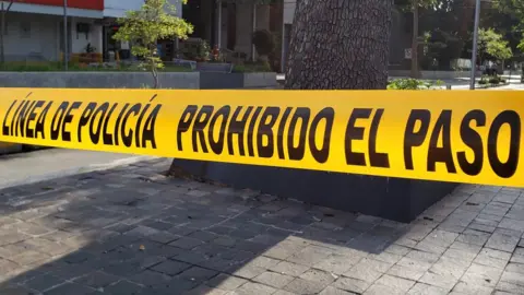 Police tape can be seen in strung across a street in central Guadalajara