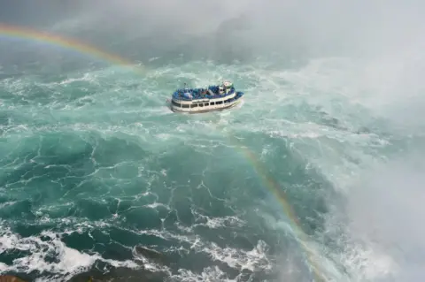 John Edwin A boat crossed by a rainbow