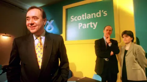 PA Media Scottish National Party leader Alex Salmond MP at the launch of the SNP Scottish election campaign in Edinburgh as fellow party members John Swinney MP and Nicola Sturgeon MP look on.