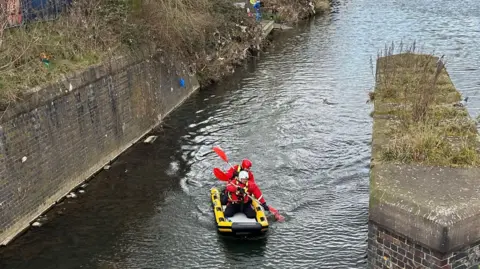 Leicestershire Fire and Rescue Service Fire crews swimming towards a deer using an inflatable sled 