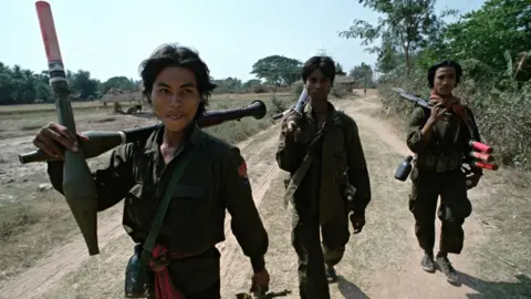 Peter Charlesworth/Getty Images Heavily armed Cambodian government soldiers patrol on a remote 'road' in 1992