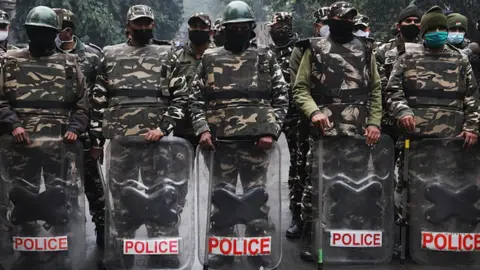 Getty Images 2021/12/28: Delhi Police personnel stand guard, during a demonstration.