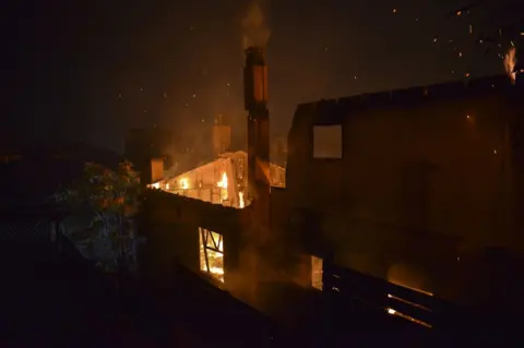AFP A house burns as a wildfire rages at the village of Mati, near Athens.