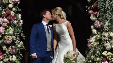 PA Media Declan Donnelly kisses his wife Ali Astall following their wedding ceremony