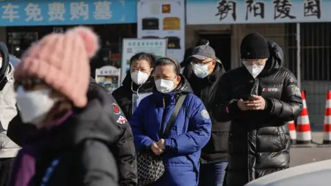 Reuters People wearing face masks walk outside a crematorium in Beijing, China, 04 January 2023.